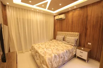 Bedrooms and Closets: bedroom with timber headboard and wardrobe (view 1)