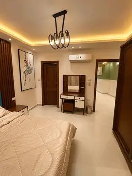 Bedrooms and Closets: bedroom with warm ceiling light and fitted furnishings (view 2)
