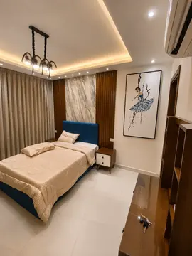Bedrooms and Closets: bedroom with warm ceiling light and fitted furnishings (view 5)