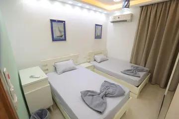 Bedrooms and Closets: light bedroom with curtains and fitted storage (view 7)