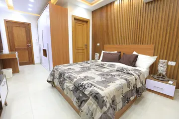 Bedrooms and Closets: bedroom with timber headboard and wardrobe (view 9)