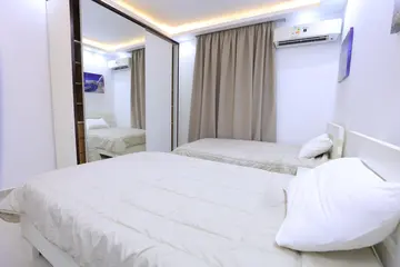 Bedrooms and Closets: light bedroom with curtains and fitted storage (view 12)