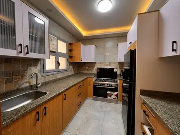 Kitchens: long galley kitchen with timber lower cabinets (view 6)