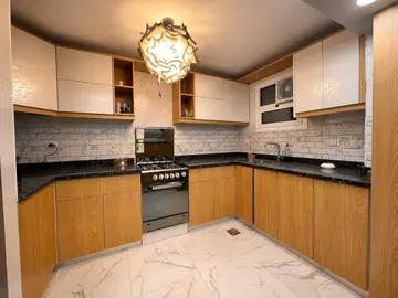 Kitchens: timber and light kitchen cabinets with a dining table (view 8)