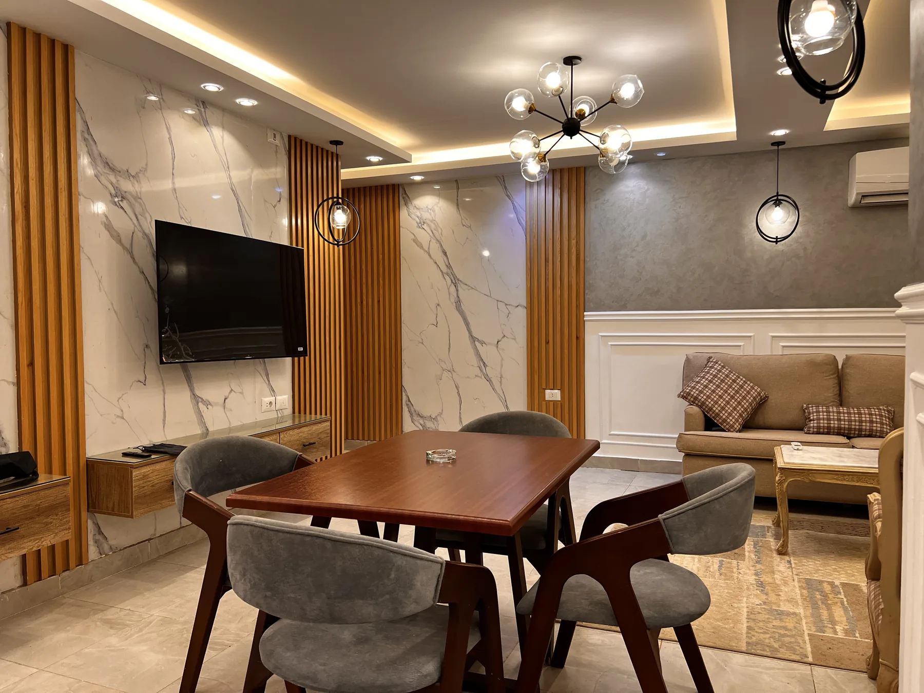 Timber Wall Cladding: slatted timber TV wall beside a dining area (view 1)