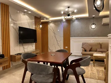 Timber Wall Cladding: slatted timber TV wall beside a dining area (view 1)
